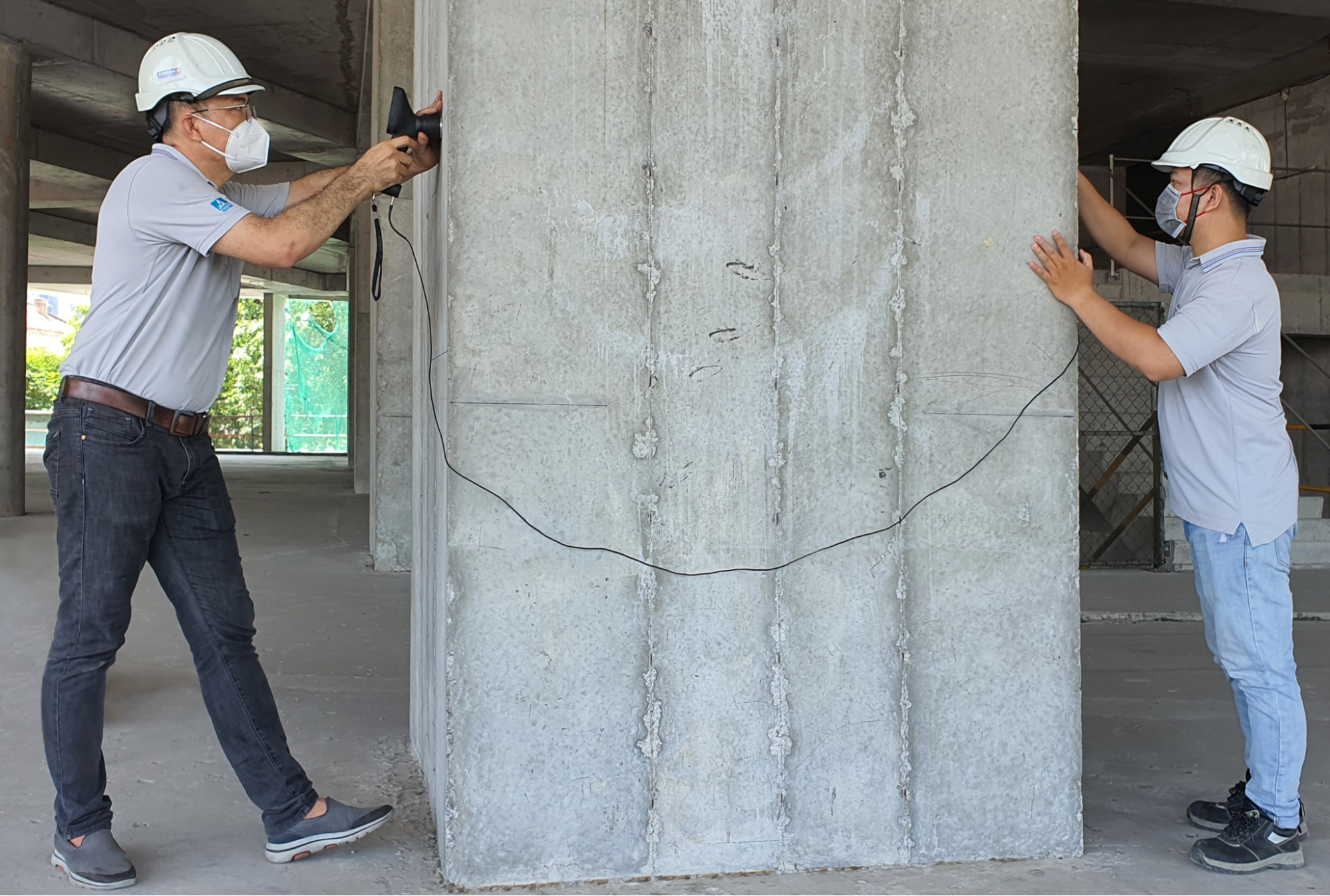 Ultrasonic Pulse Velocity Testing (UPVT) of a concrete pole for evaluating the compressive strength